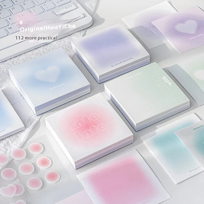 Square gradient-cover notepad showing pastel colours, open to reveal sticky notes, plain paper, and parchment sheets.