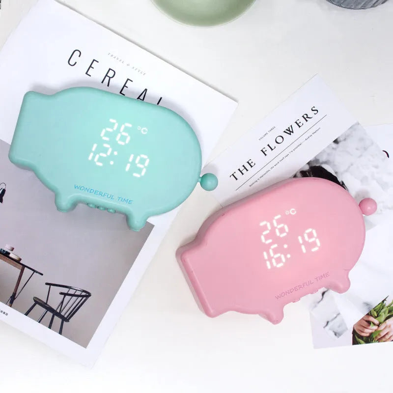 Multifunctional charging LED alarm clock with temperature display, USB-powered bedside clock featuring 1000mAh battery capacity, available in blue and pink ABS+PC construction, suitable for bedroom, desk, or travel use