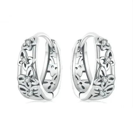 Sterling silver retro hollow butterfly earrings with zircon stones on a white background.