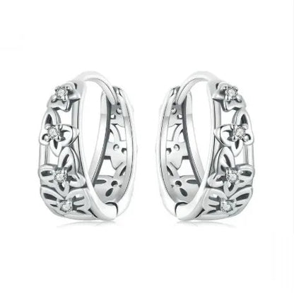 Sterling silver retro hollow butterfly earrings with zircon stones on a white background.