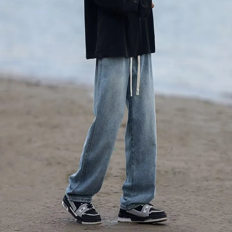 Straight-leg loose fit men's jeans in blue denim with drawstring waist for casual spring summer wear