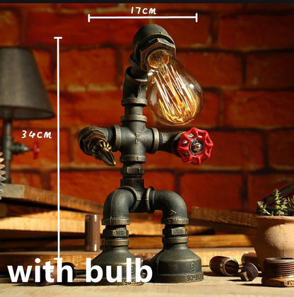 Vintage industrial iron pipe table lamp with soft, warm lighting and a green bronze finish