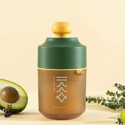 Premium manual citrus juicer in white, green, and pink colors, featuring a compact, portable design for effortless juice extraction