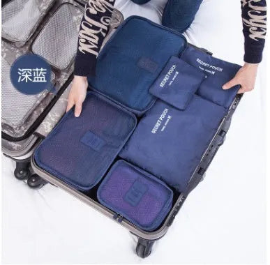 Set of six coloured nylon packing cubes and flat pouches for travel organisation.