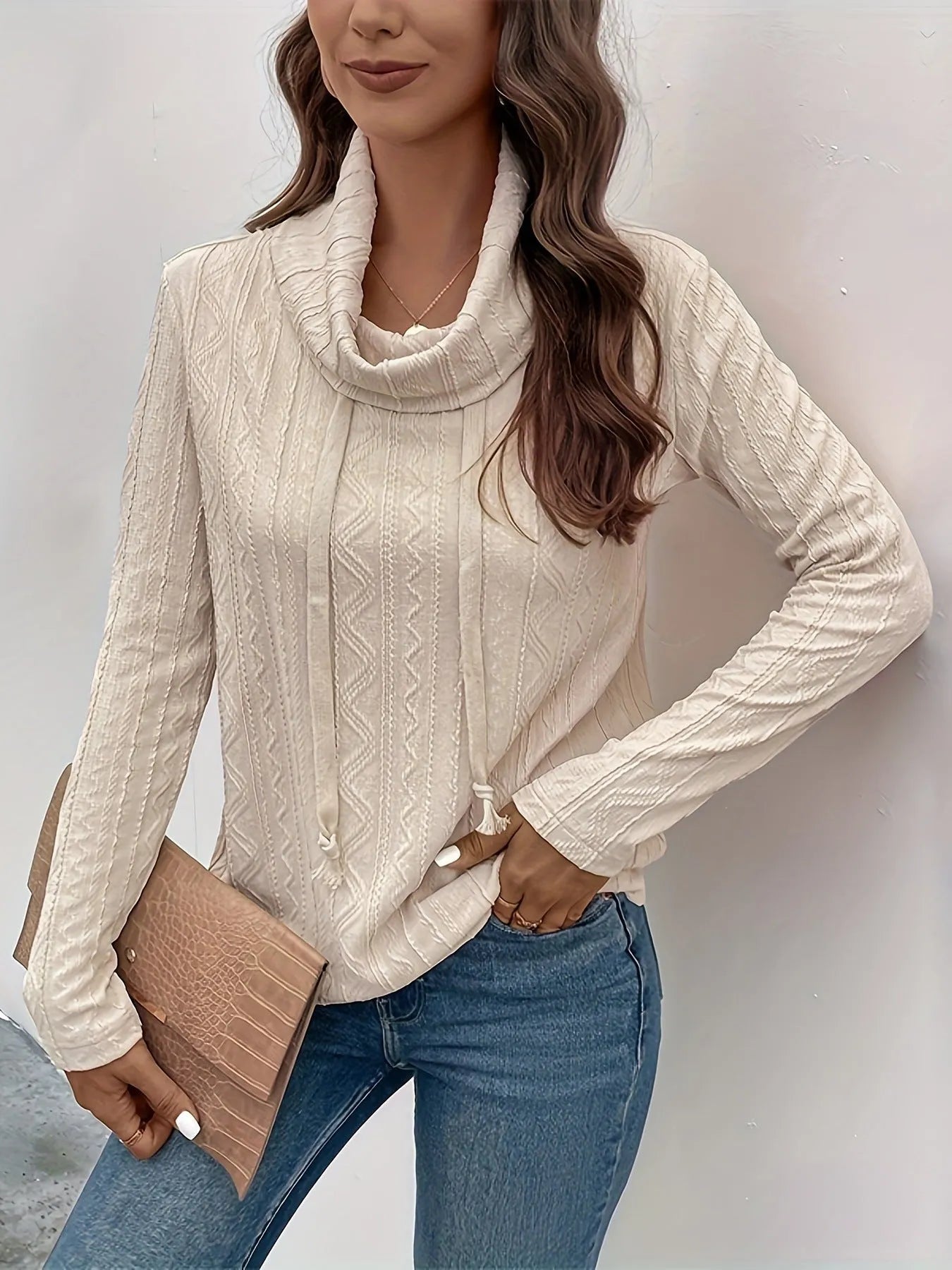 Apricot coloured long sleeve hooded pullover sweater with drawstring on a hanger