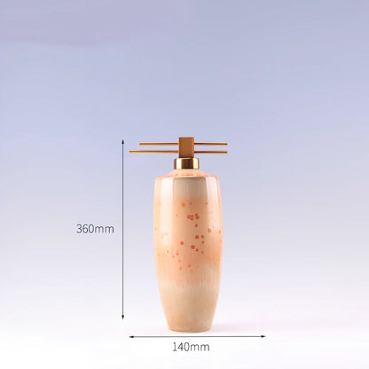 Handmade ceramic ornaments in graduated sizes with emerald green and golden sunlight glazes