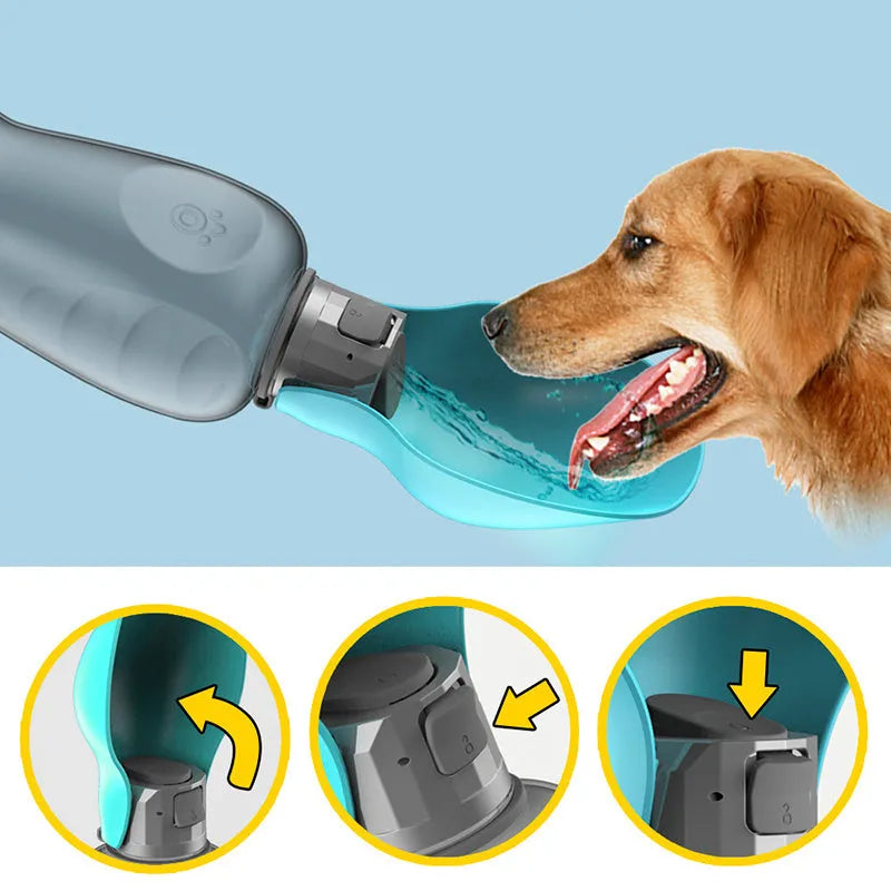 Blue grey portable dog water bottle with foldable drinking bowl and wrist strap, shown next to a dog.
