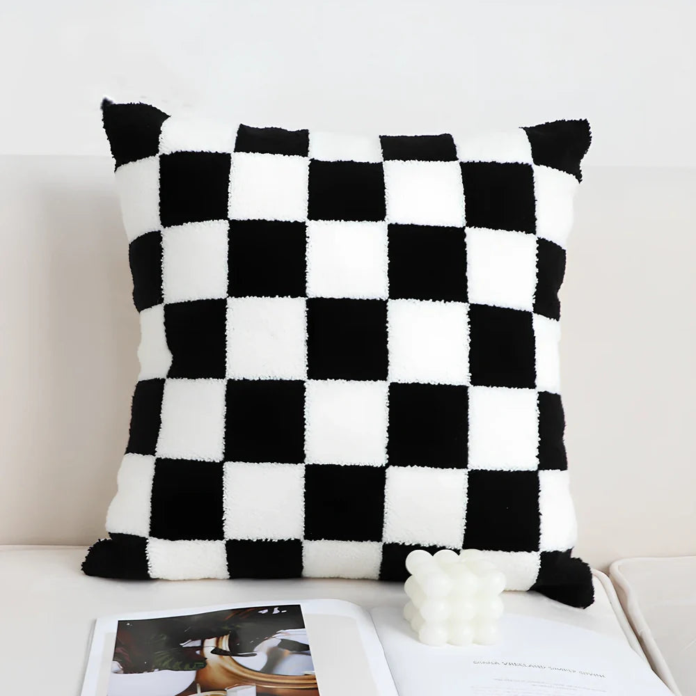 Black and white checkerboard square pillow measuring 45cm on sofa