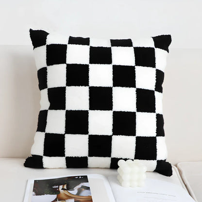 Black and white checkerboard square pillow measuring 45cm on sofa