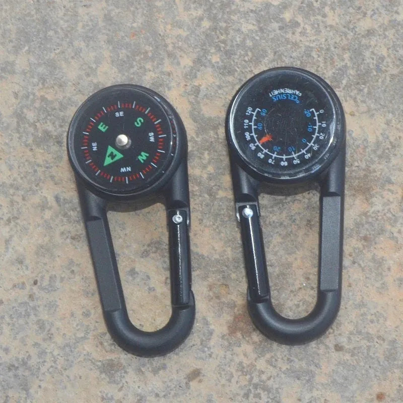 Black outdoor carabiner with a built-in circular compass and thermometer display on its side.