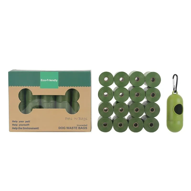 Roll of EPI green degradable pet waste bags next to a transparent dispenser on a grass background.