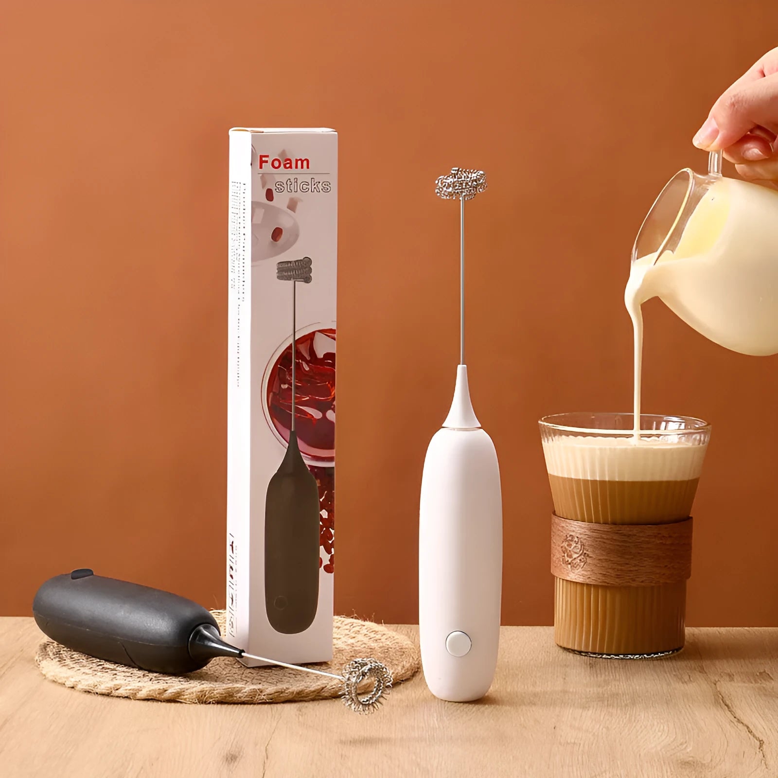 Hand-held electric milk frother in black or white colour, modern design for frothing and blending beverages