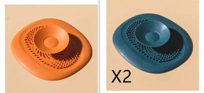 TPR vortex design sink drain cover in twilight orange, quiet blue, mango yellow, and gentian green