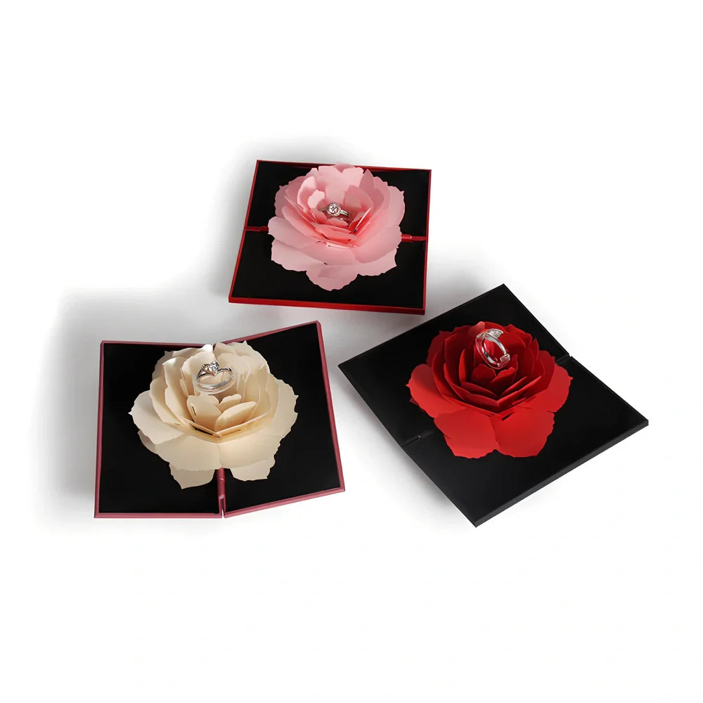 Rotating ring box with embossed paper exterior showing 360-degree mechanism and flannel interior