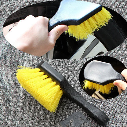 Car tire wheel brush with long handle and twisted yarn bristles for wheel hub cleaning.