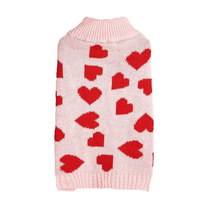Red love heart pattern dog sweater with pink bow decoration on small dog