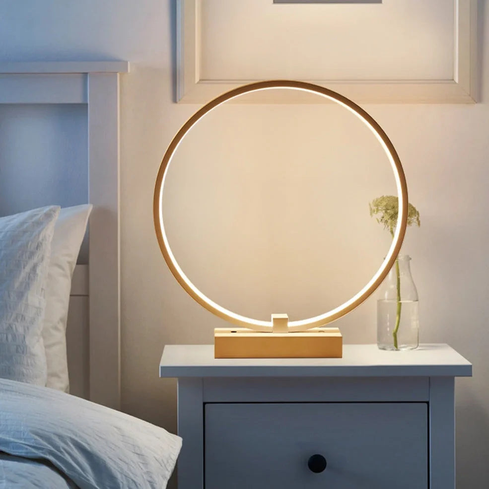 White circular LED bedside lamp with 25cm diameter on iron base showing warm white illumination
