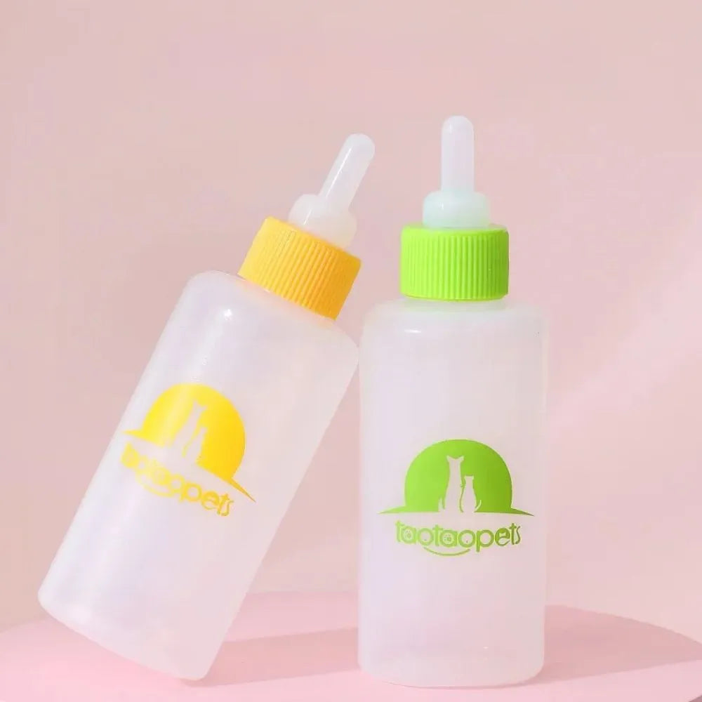 Four pet milk bottles in blue, green, pink and yellow colours with cleaning brush for small animal feeding