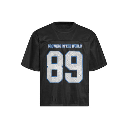 Man modelling a black loose-fitting T-shirt with a white alphanumeric graphic print on the chest.