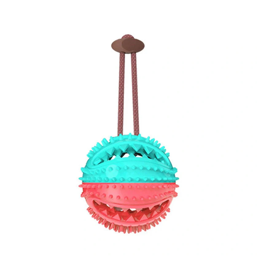 Red and blue silicone dog ball toy with suction cup attached to tile surface