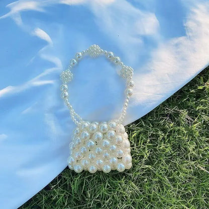 Women's imitation pearl mini crossbody handbag with geometric pattern in a pearl colour.