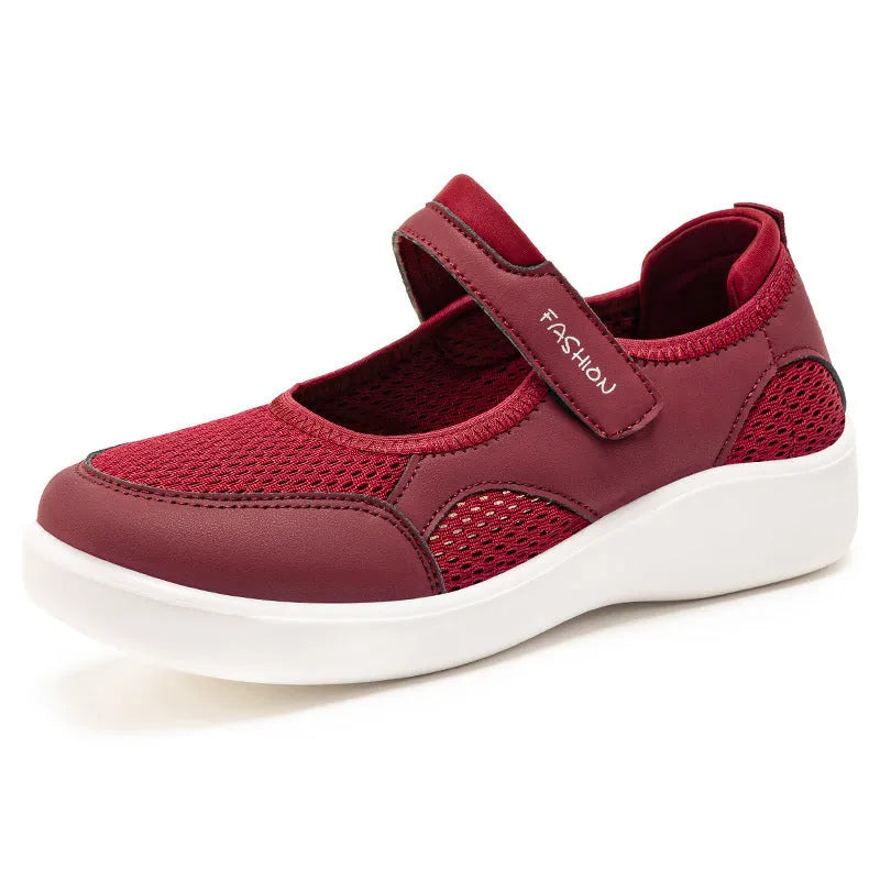 Women's grey velcro casual shoes with mesh upper and flat sole.