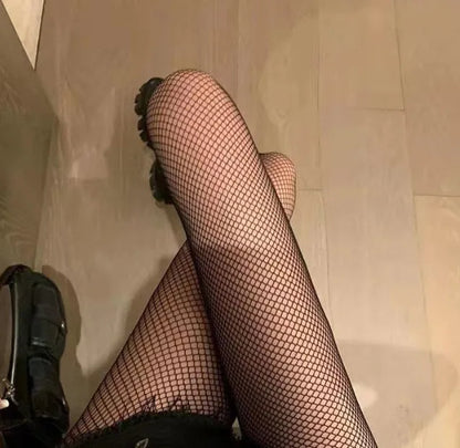Women's black and white mesh stockings showing large, medium, and small hole patterns.