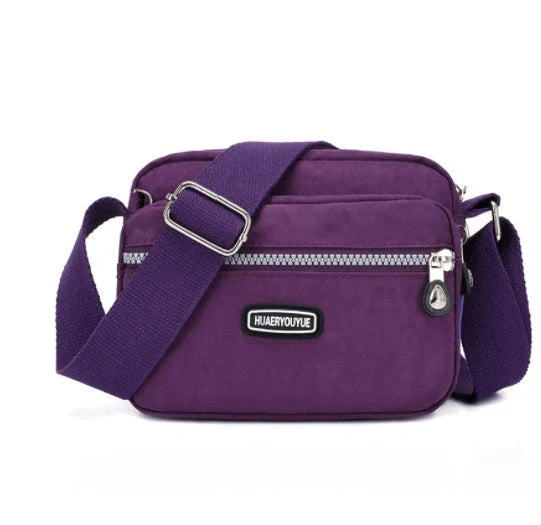 Compact nylon messenger bag in various colors with multiple compartments
