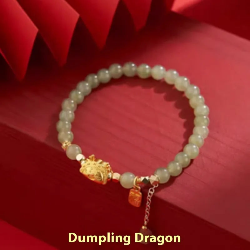 Women's Chinese style bracelet with Hetian jade, red agate beads, and a dragon design on gold and silver.