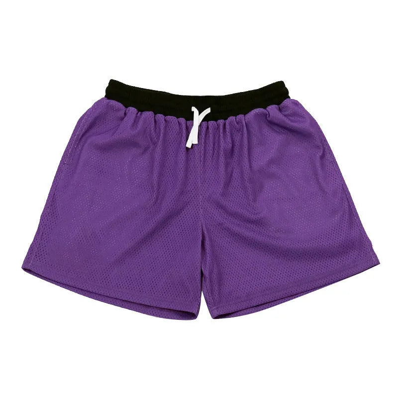 Men's black athletic shorts with grey mesh side panels for breathability, laid flat on a surface.