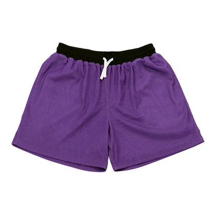 Men's black athletic shorts with grey mesh side panels for breathability, laid flat on a surface.