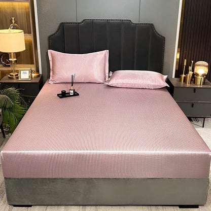 Houndstooth ice silk jacquard fitted three-piece bedding set in ice blue, 180x200cm size with pillowcases on white bed