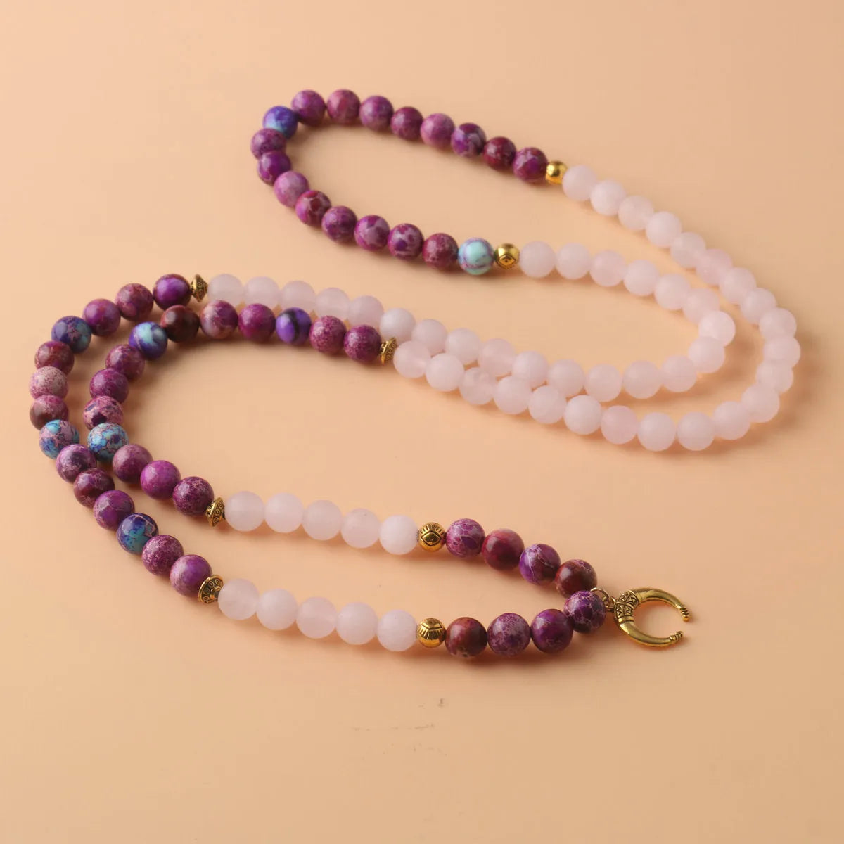 Round pink crystal emperor stone bead pendant on a women's personalised necklace.