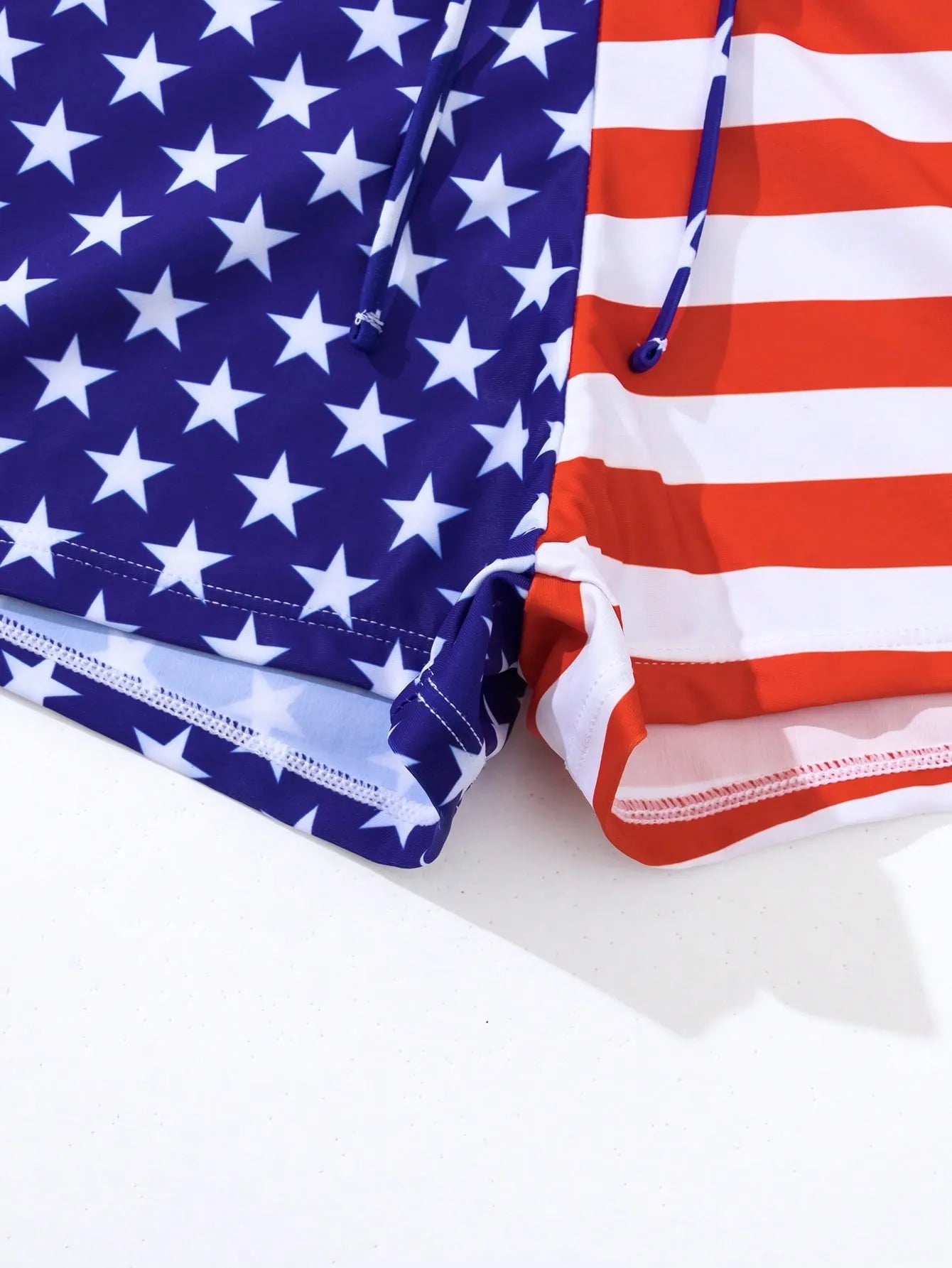 Women's blue and red Stars and Stripes high waist boxer swim shorts with a white drawstring.