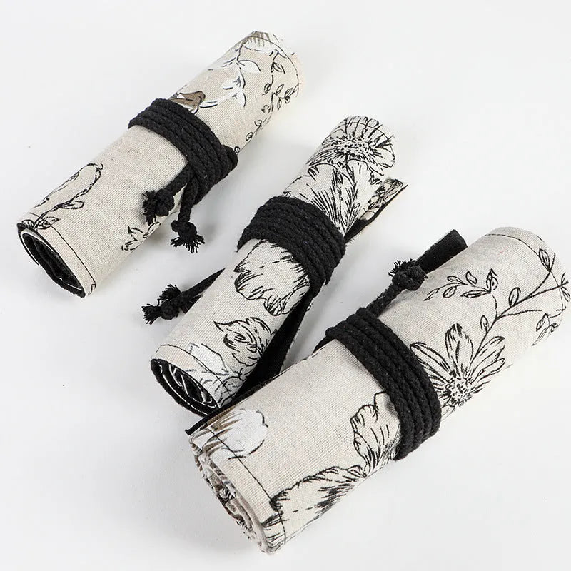 Black peony floral print canvas pencil roll bag open to show 24 or 72 pencil slots.