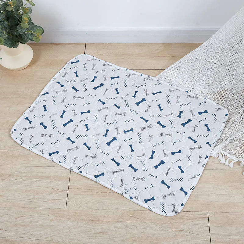 Reusable cloth pet urine pad with animal print and waterproof non-slip backing in various sizes.