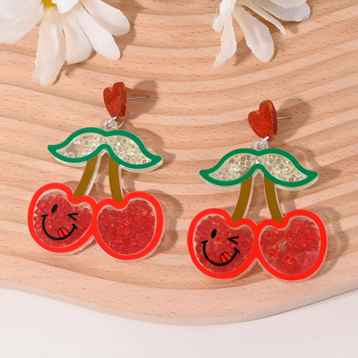 Colourful acrylic earrings with fruit and dessert designs including cherry, strawberry, watermelon, pineapple, coconut, cake and ice cream motifs