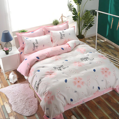 Three-piece cotton bedding set with blue geometric pattern showing duvet cover, fitted sheet, and two pillowcases on a UK double bed