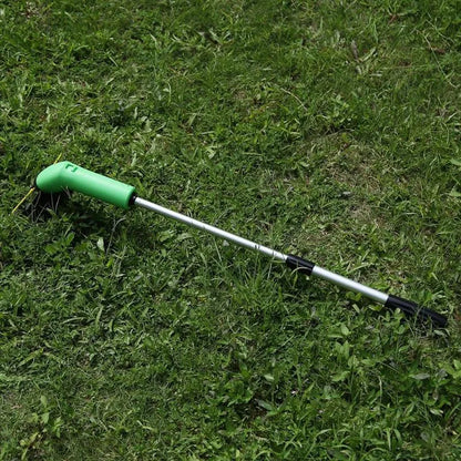 Cordless handheld lawn trimmer with green housing, extension pole, debris shield, and pack of zip ties on a garden lawn.
