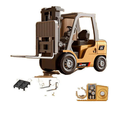 Miniature grey alloy remote control forklift toy with cargo forks and a pallet on a table.