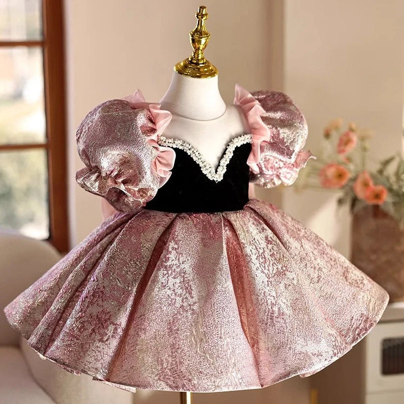 Pink children's princess dress with cute design elements, shown on hanger