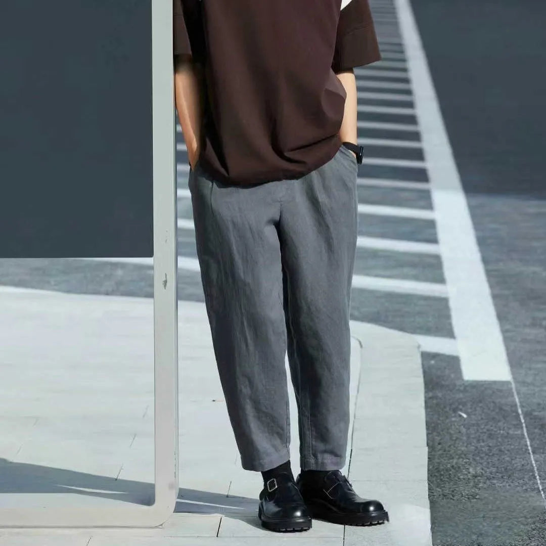Men's loose straight casual pants with drawstring waist in navy blue colour, showing relaxed fit and straight leg design