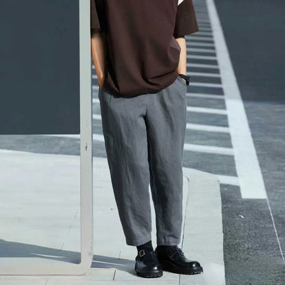 Men's loose straight casual pants with drawstring waist in navy blue colour, showing relaxed fit and straight leg design