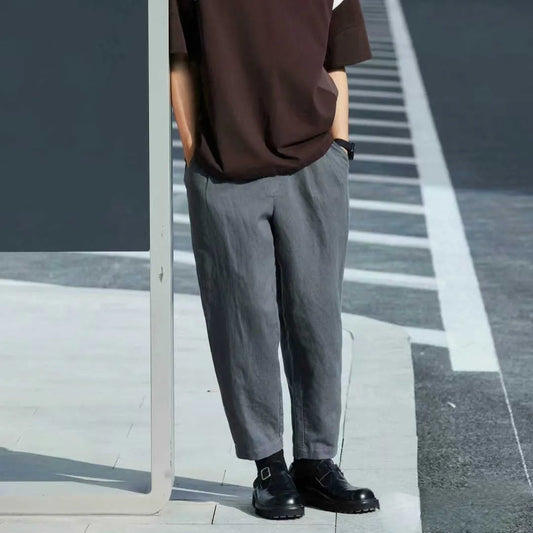 Men's loose straight casual pants with drawstring waist in navy blue colour, showing relaxed fit and straight leg design