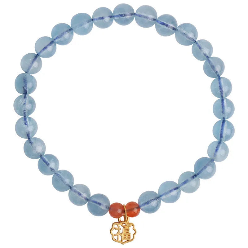 Ice translucent aquamarine crystal bracelet with 8mm round beads and sequin details on a wrist.