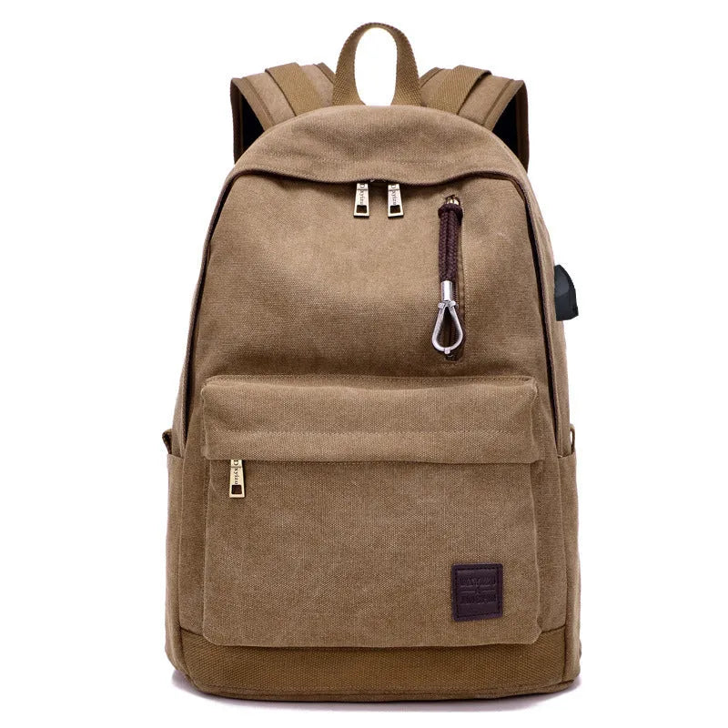 Coffee-coloured canvas backpack with USB charging port on side strap and front zipper pocket.