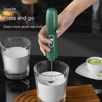 Battery-powered handheld milk frother in retro green, black, or white with stainless steel whisk