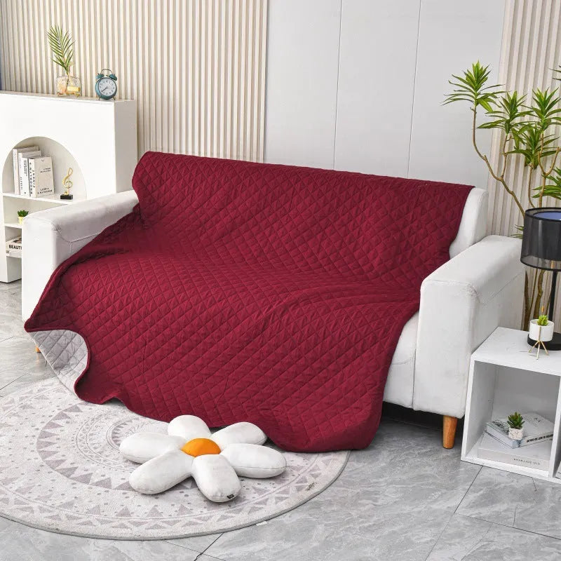 Reversible dog blanket sofa cover in burgundy and grey, laid flat on a sofa