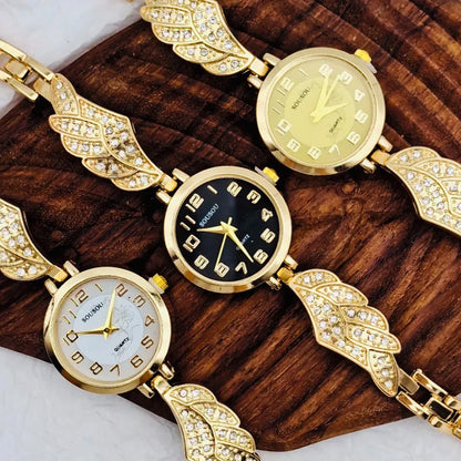 Round stainless steel women's watch on wrist showing gold surface colour and vachette clasp buckle.
