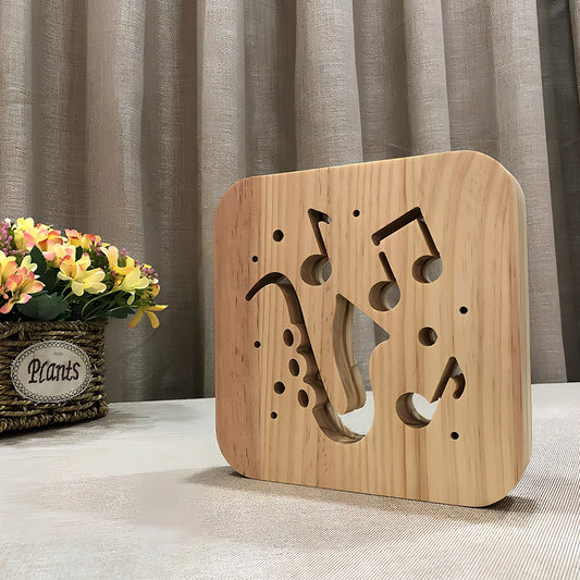 Wood-carved music instrument LED night light with USB cable showing guitar, saxophone, and violin designs